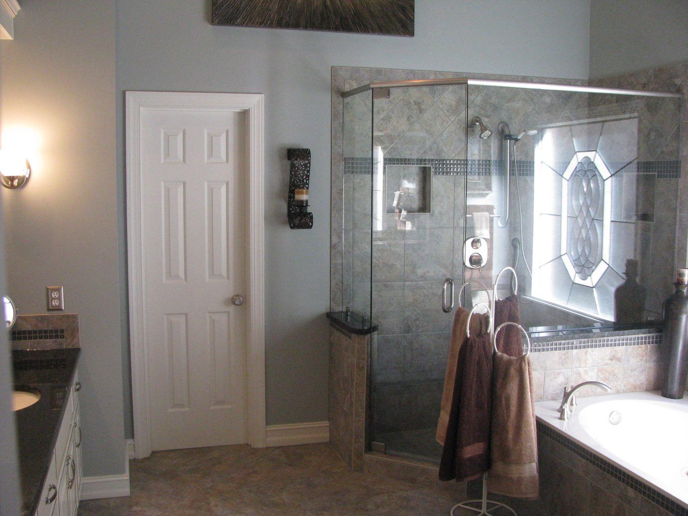 Spa-style bathroom with arched window